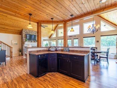 kitchen featuring light wood-style floors, wood ceiling, and hanging light fixtures