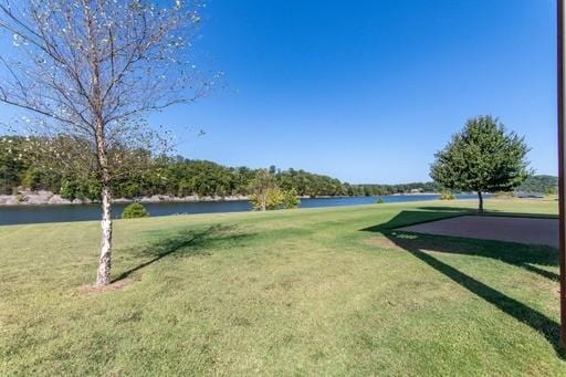 view of community featuring a lawn and a water view