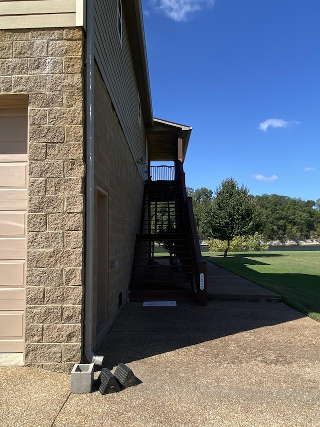 view of property exterior with a garage and stairs