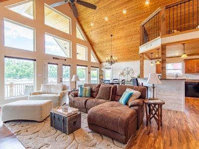 living room featuring a wealth of natural light, wood ceiling, high vaulted ceiling, and wood finished floors