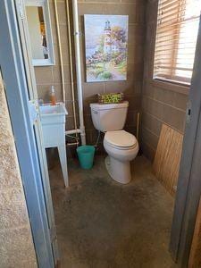 bathroom featuring tile walls and toilet