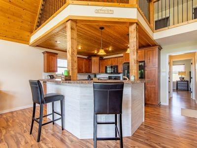 kitchen with high vaulted ceiling, a wealth of natural light, wooden ceiling, and brown cabinets