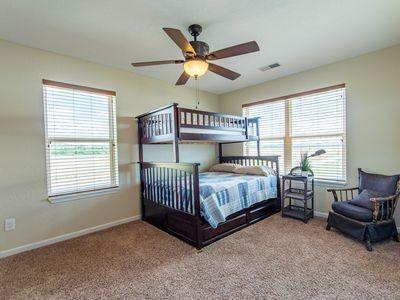 bedroom with multiple windows, carpet flooring, and visible vents