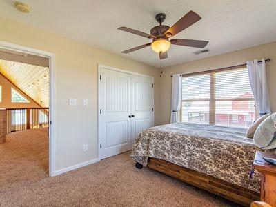 carpeted bedroom featuring a ceiling fan, a closet, visible vents, and baseboards