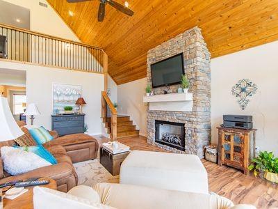 living area featuring wood ceiling, stairs, and wood finished floors