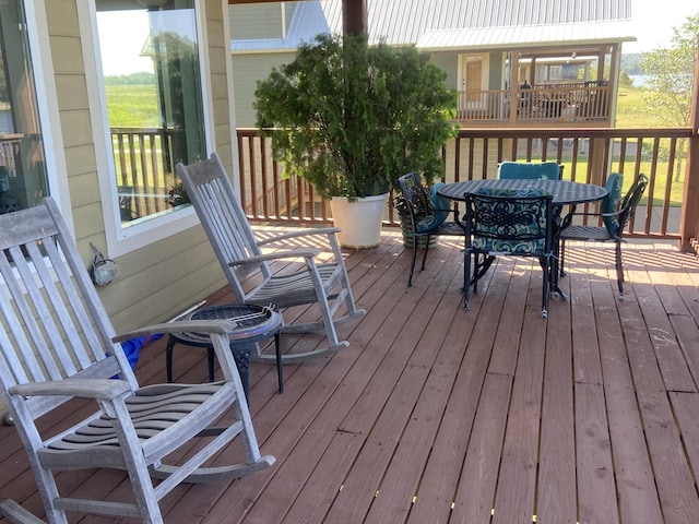 deck with outdoor dining area