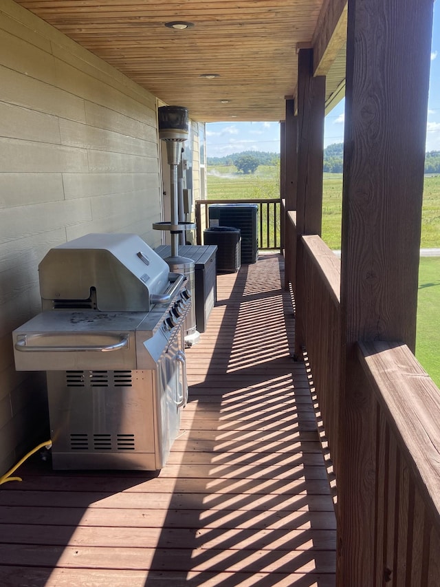 wooden deck featuring grilling area and central air condition unit