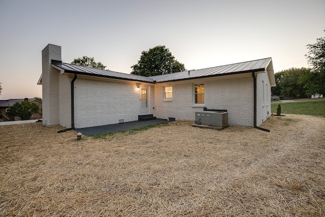 back house at dusk with a yard