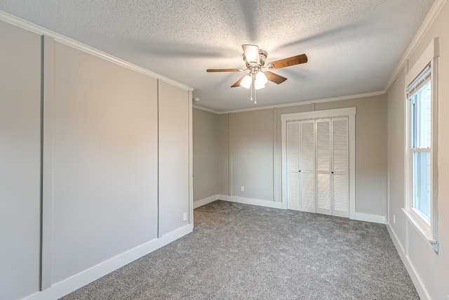 unfurnished bedroom featuring ceiling fan, crown molding, and carpet flooring