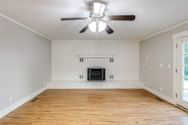 unfurnished living room featuring ceiling fan, light hardwood / wood-style flooring, brick wall, and ornamental molding