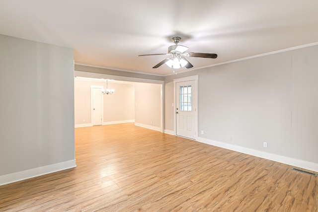 spare room featuring light hardwood / wood-style flooring, ceiling fan with notable chandelier, and ornamental molding