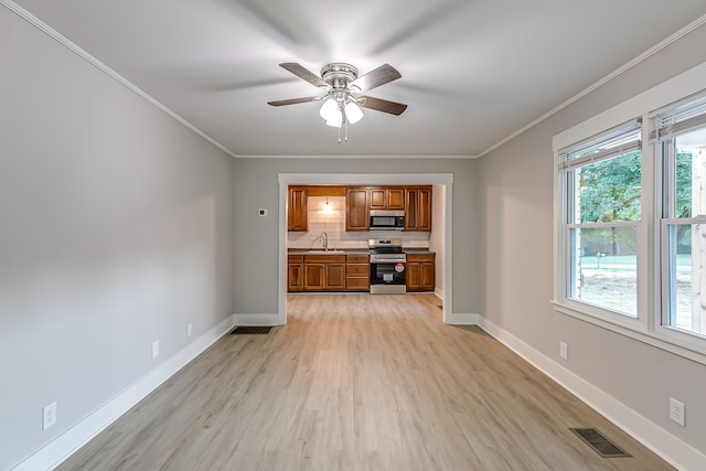 unfurnished living room with sink, light hardwood / wood-style flooring, ceiling fan, and crown molding