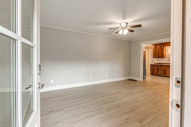 unfurnished room featuring ceiling fan, light hardwood / wood-style flooring, and crown molding