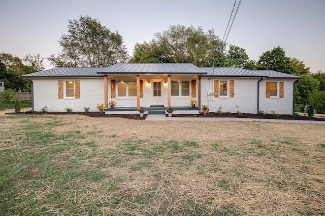 view of front of house featuring a front lawn and a porch