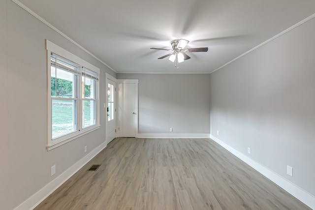 empty room with ceiling fan, crown molding, and light hardwood / wood-style floors