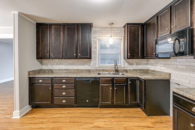 kitchen featuring sink, light hardwood / wood-style flooring, black appliances, and dark brown cabinets