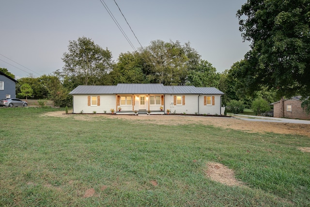 view of front of house with a porch and a front lawn