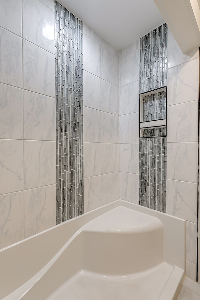 bathroom with tile walls and a tile shower