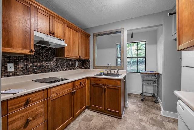 kitchen featuring light tile patterned floors, sink, tasteful backsplash, and a textured ceiling