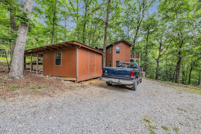 view of side of property featuring a storage shed