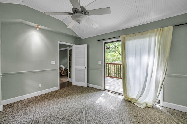 carpeted spare room with ceiling fan and vaulted ceiling