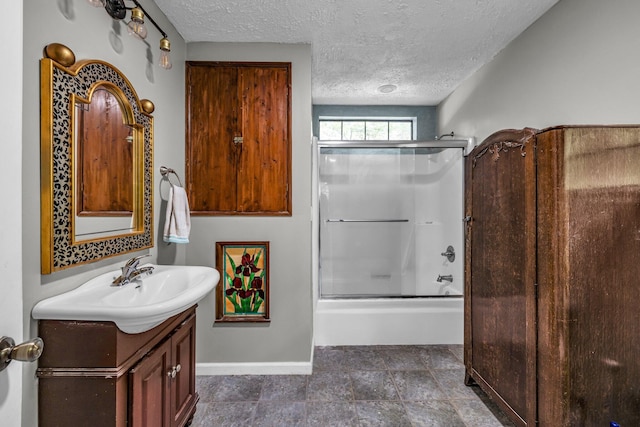 bathroom featuring tile patterned floors, a textured ceiling, vanity, and enclosed tub / shower combo