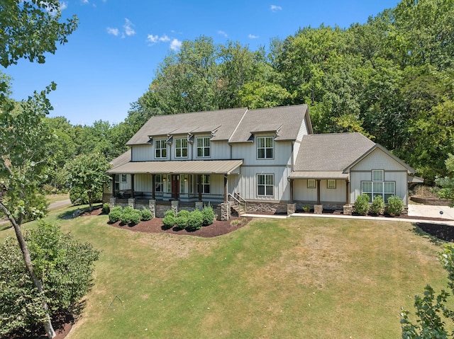 5345 Forest Acres Dr, Nashville, TN 37220 - view of front facade with stone siding, a standing seam roof, a porch, and a front yard