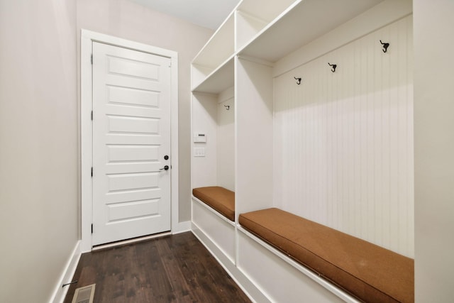 mudroom with dark wood-style floors, baseboards, and visible vents