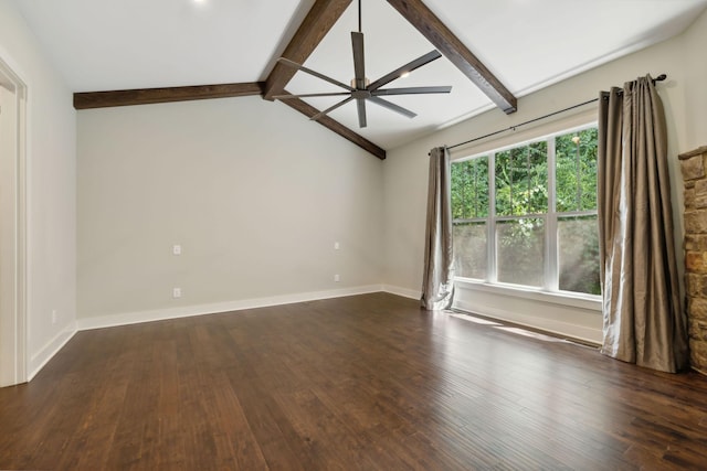 spare room with lofted ceiling with beams, dark wood finished floors, a ceiling fan, and baseboards