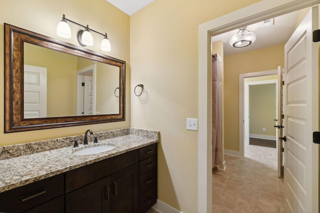 bathroom featuring baseboards and vanity