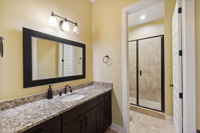 full bath with a stall shower, baseboards, vanity, and toilet