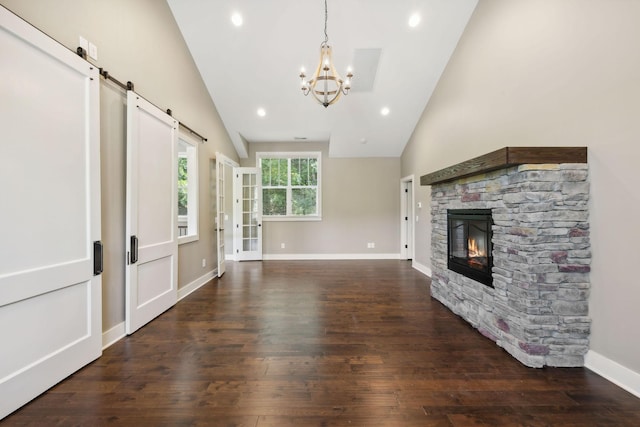 unfurnished living room with baseboards, dark wood-style floors, a stone fireplace, a chandelier, and recessed lighting