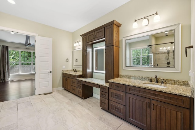 bathroom with a wealth of natural light, a sink, and a stall shower