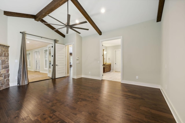 empty room with vaulted ceiling with beams, ceiling fan, hardwood / wood-style floors, and baseboards