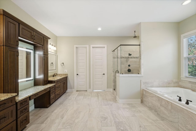 bathroom with a garden tub, recessed lighting, a stall shower, vanity, and baseboards