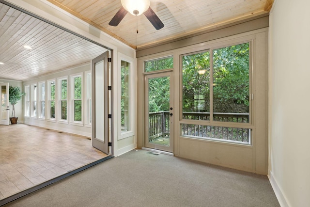 unfurnished sunroom with wooden ceiling, plenty of natural light, and ceiling fan