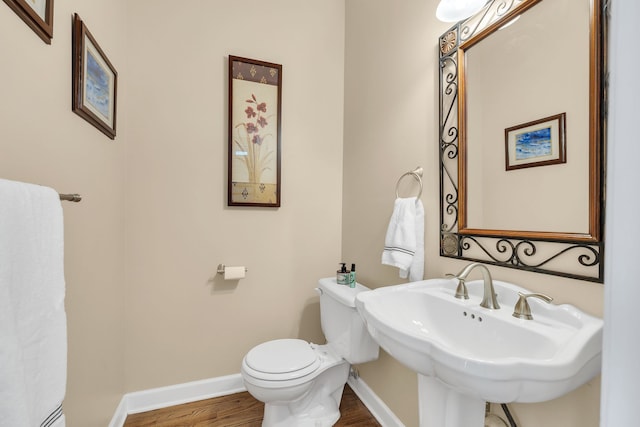 bathroom featuring sink, toilet, and wood-type flooring