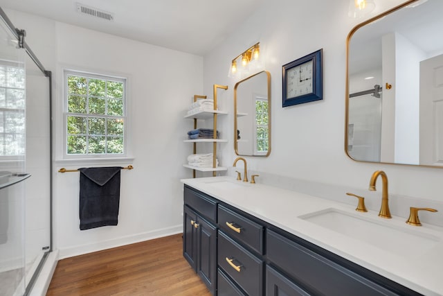 bathroom featuring an enclosed shower, vanity, and hardwood / wood-style floors