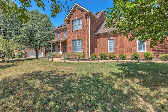 view of front of home with a front yard and a garage