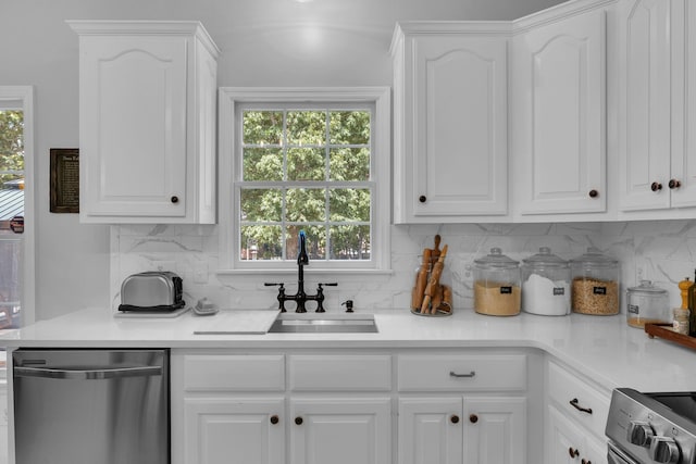 kitchen featuring stainless steel appliances, white cabinets, and plenty of natural light