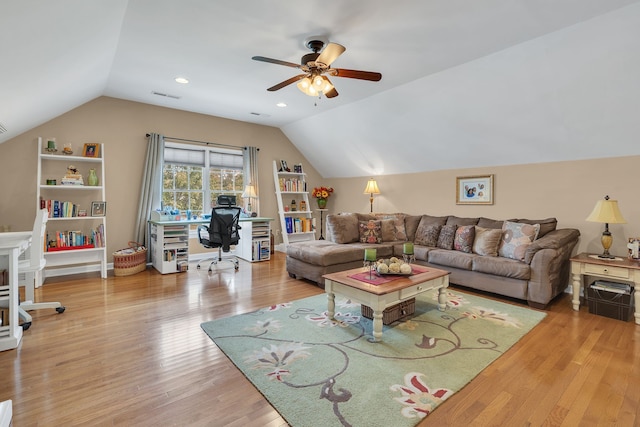 living room featuring light hardwood / wood-style floors, ceiling fan, and lofted ceiling