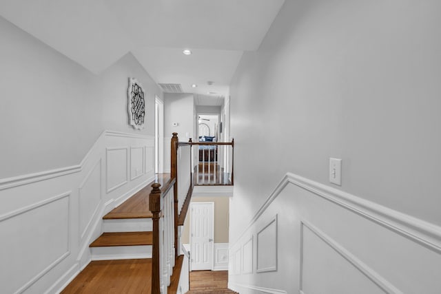 stairs with hardwood / wood-style flooring