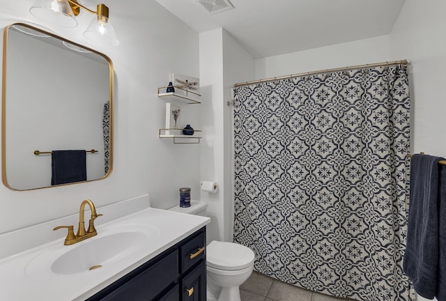 bathroom with tile patterned floors, curtained shower, vanity, and toilet