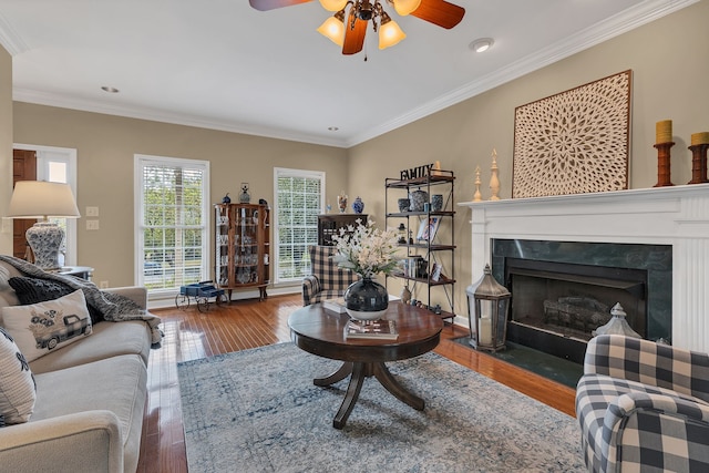 living room with ceiling fan, crown molding, and hardwood / wood-style floors