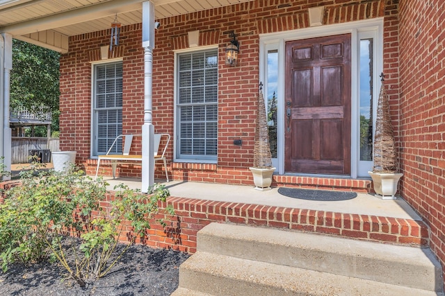 doorway to property featuring covered porch