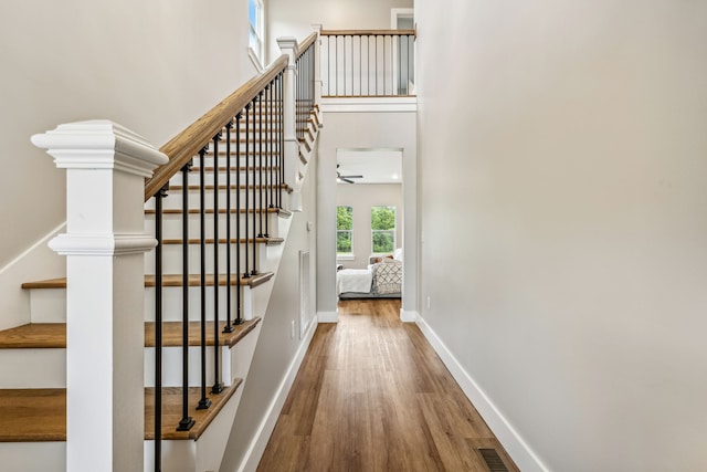 interior space featuring hardwood / wood-style flooring and a towering ceiling