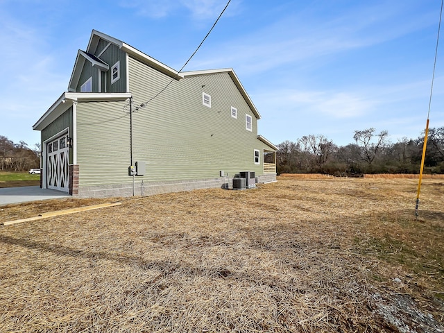 view of side of home featuring central AC