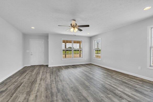 unfurnished living room featuring ceiling fan, a textured ceiling, and hardwood / wood-style floors