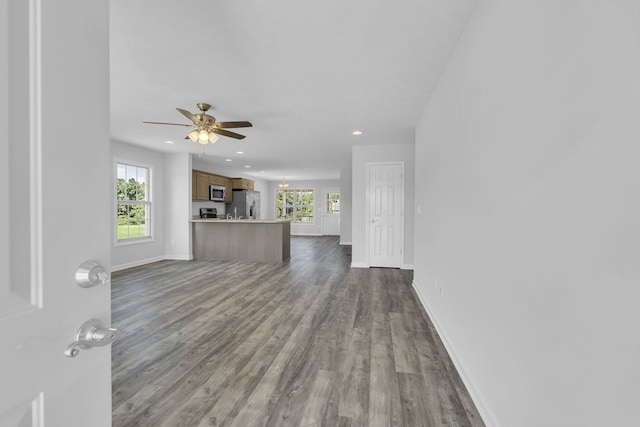 unfurnished living room featuring a wealth of natural light, hardwood / wood-style flooring, and ceiling fan