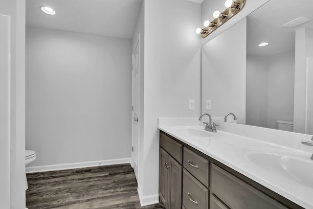 bathroom with vanity, hardwood / wood-style floors, and toilet